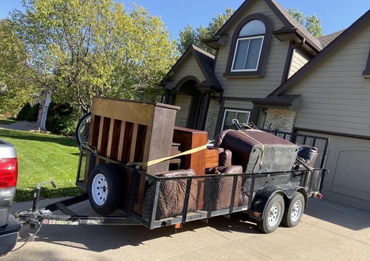 A trailer containing furniture and miscellaneous items, highlighting the offerings of Specialized Junk Service in Chicago, IL.